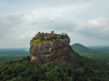 Rock formations on landscape against sky