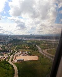 Distant view of airplane wing over landscape