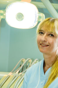 Portrait of smiling dentist at hospital