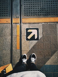 Low section of person standing on footpath