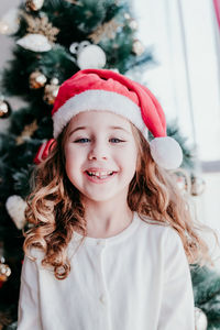 Close-up of smiling girl at home during christmas 