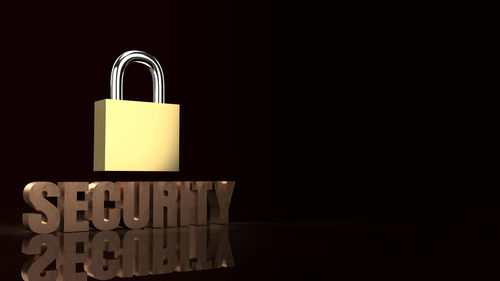 Close-up of padlocks against black background