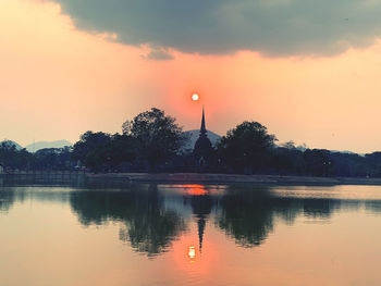 Scenic view of lake against romantic sky at sunset