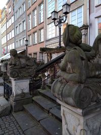 Statue against building in city