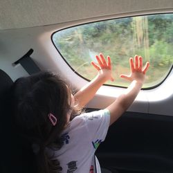 Rear view of woman in car window