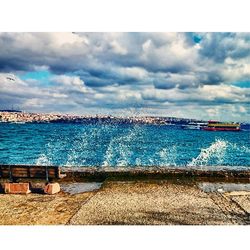 Scenic view of sea against cloudy sky