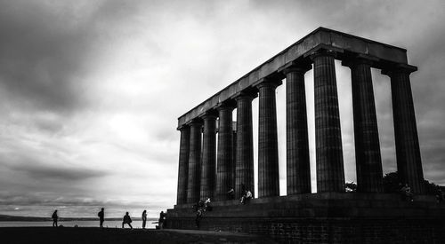 Low angle view of historical building against cloudy sky