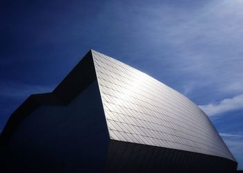 Low angle view of modern building against blue sky