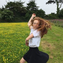 Woman standing on grassy field