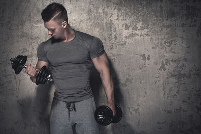 Young man exercising in gym