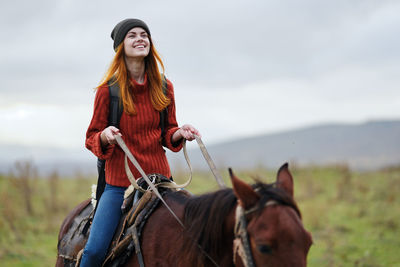 Young woman riding horse