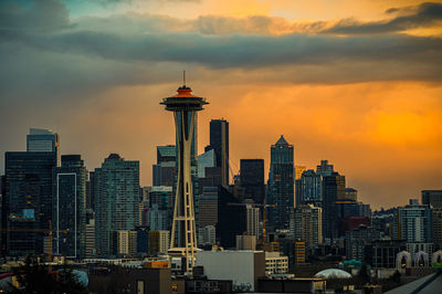 Skyscrapers in city against sky during sunset