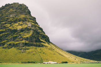 Scenic view of majestic mountain against cloudy sky