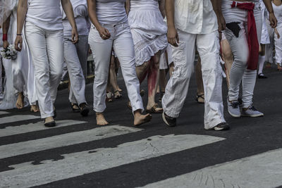Rear view of people walking on road
