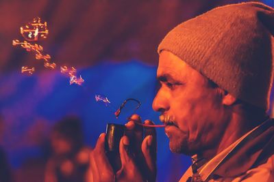 Close-up of man blowing bubble