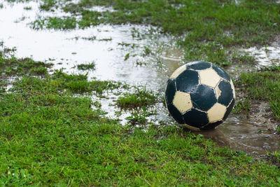 Soccer ball on field by lake