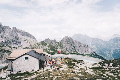 Scenic view of mountains and buildings against sky