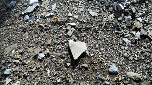 High angle view of broken rocks on field