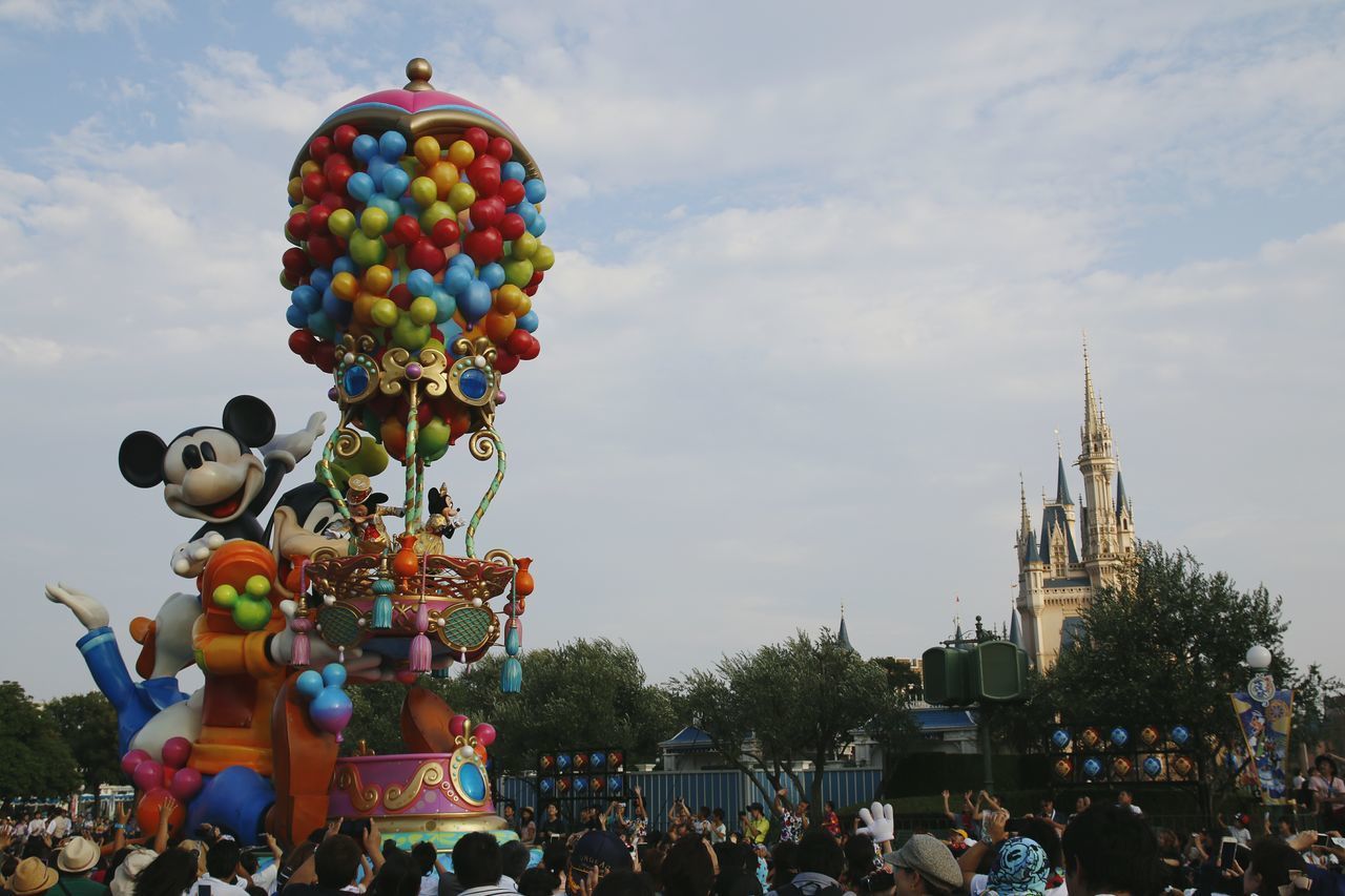 GROUP OF PEOPLE ON BALLOONS AGAINST SKY