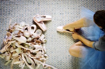 High angle view of woman wearing ballet shoe