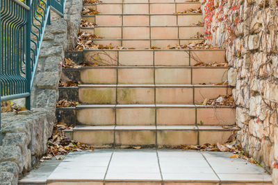 Staircase by wall of old building