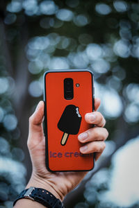 Midsection of man using mobile phone