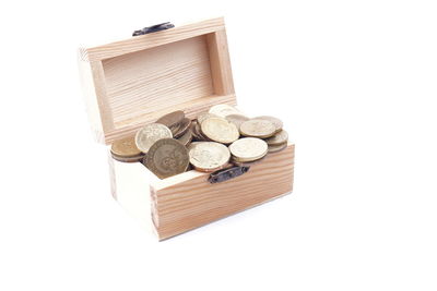 High angle view of coins on table against white background