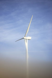 Low angle view of wind turbine against sky