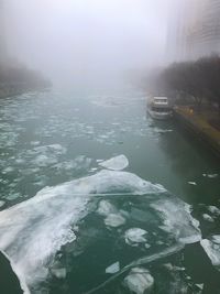 Scenic view of frozen lake in foggy weather