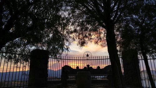 Low angle view of silhouette trees against sky at sunset