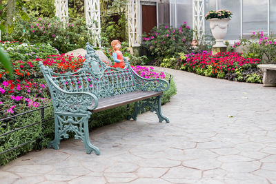 Woman sitting by potted plants in yard