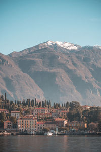Scenic view of river and buildings against clear sky