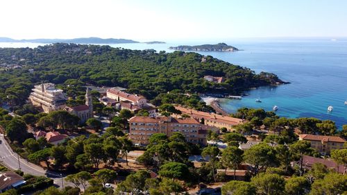 High angle view of townscape by sea against sky