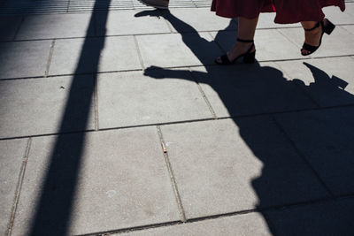 Low section of woman walking on street