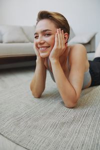 Portrait of sensuous woman sitting on bed at home