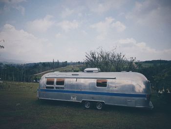 Vintage car on field against sky