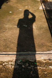 Shadow of man on footpath