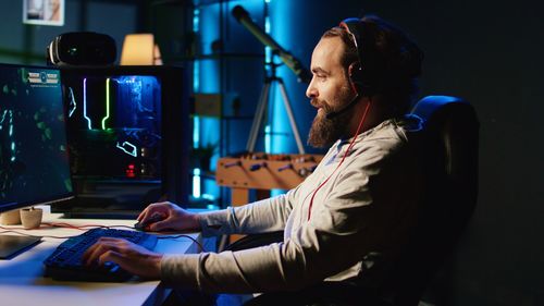 Side view of young man working at office