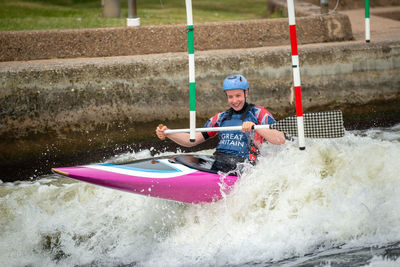 Young woman kayaking on river