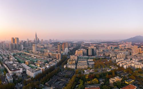 High angle view of city buildings against sky during sunset