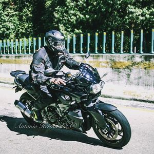 Man riding motorcycle sitting on road