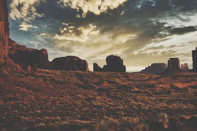 Rock formations on landscape against sky