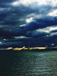 Scenic view of sea against storm clouds