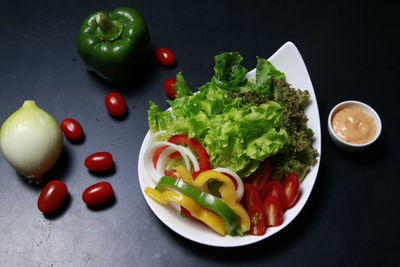 High angle view of chopped vegetables in plate on table