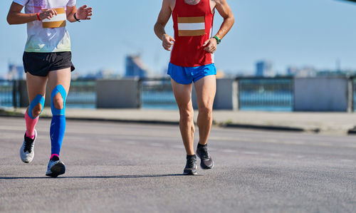 Running men. sportsmen jogging in sportswear on city road. healthy lifestyle, fitness hobby