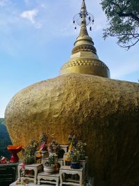 Statue against temple against sky