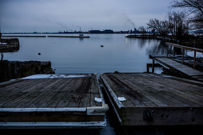 Pier over lake against sky