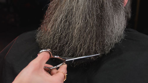 Cropped hand of woman holding hair