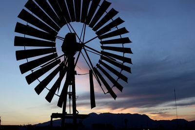 Low angle view of traditional windmill against sky