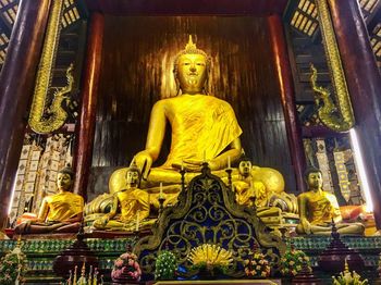 Low angle view of statue against temple building